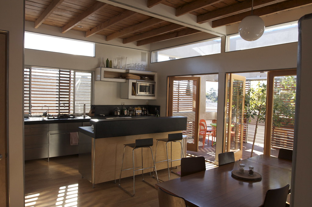 Open plan kitchen and dining renovation with timber ceiling beams