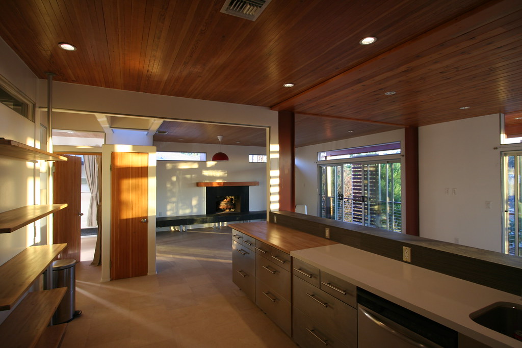 Kitchen renovation with feature timber ceiling and living area beyond