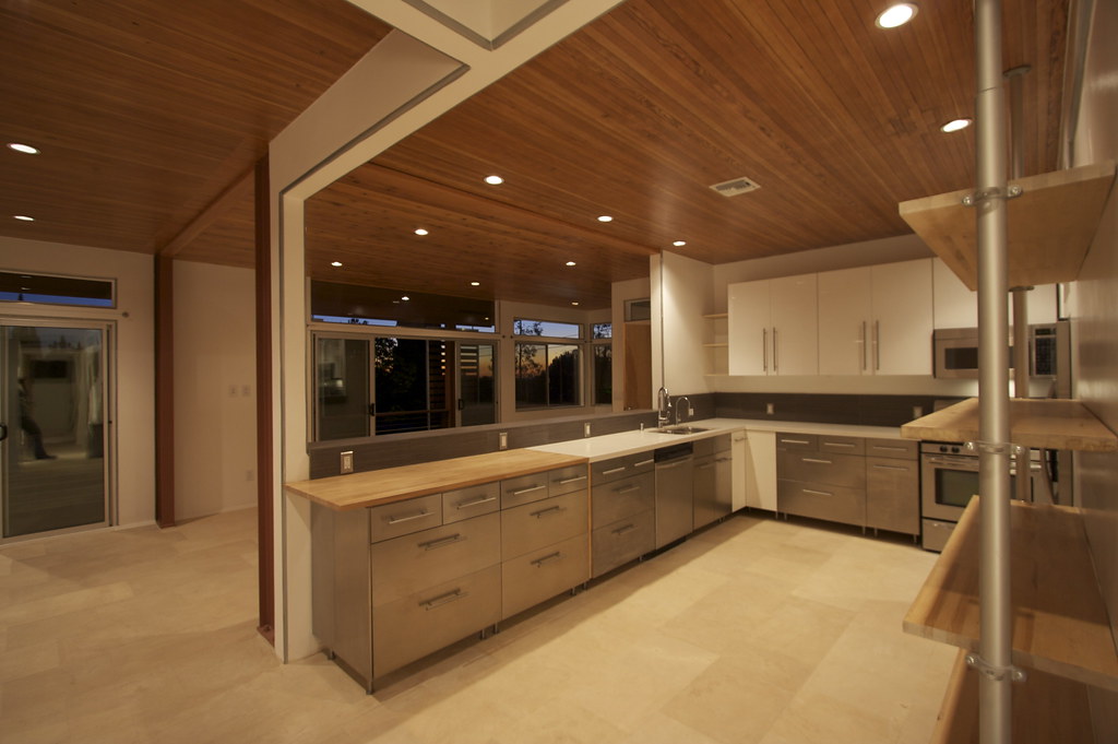 Kitchen cabinetry and island bench at dusk