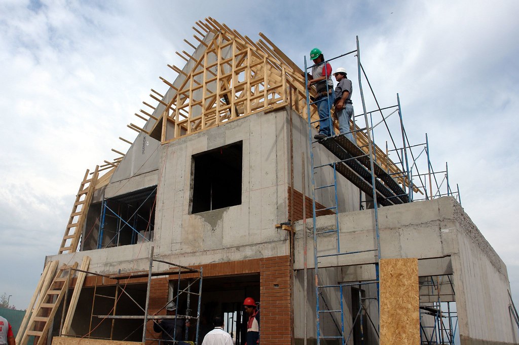 Timber frame roof under construction on a custom home build